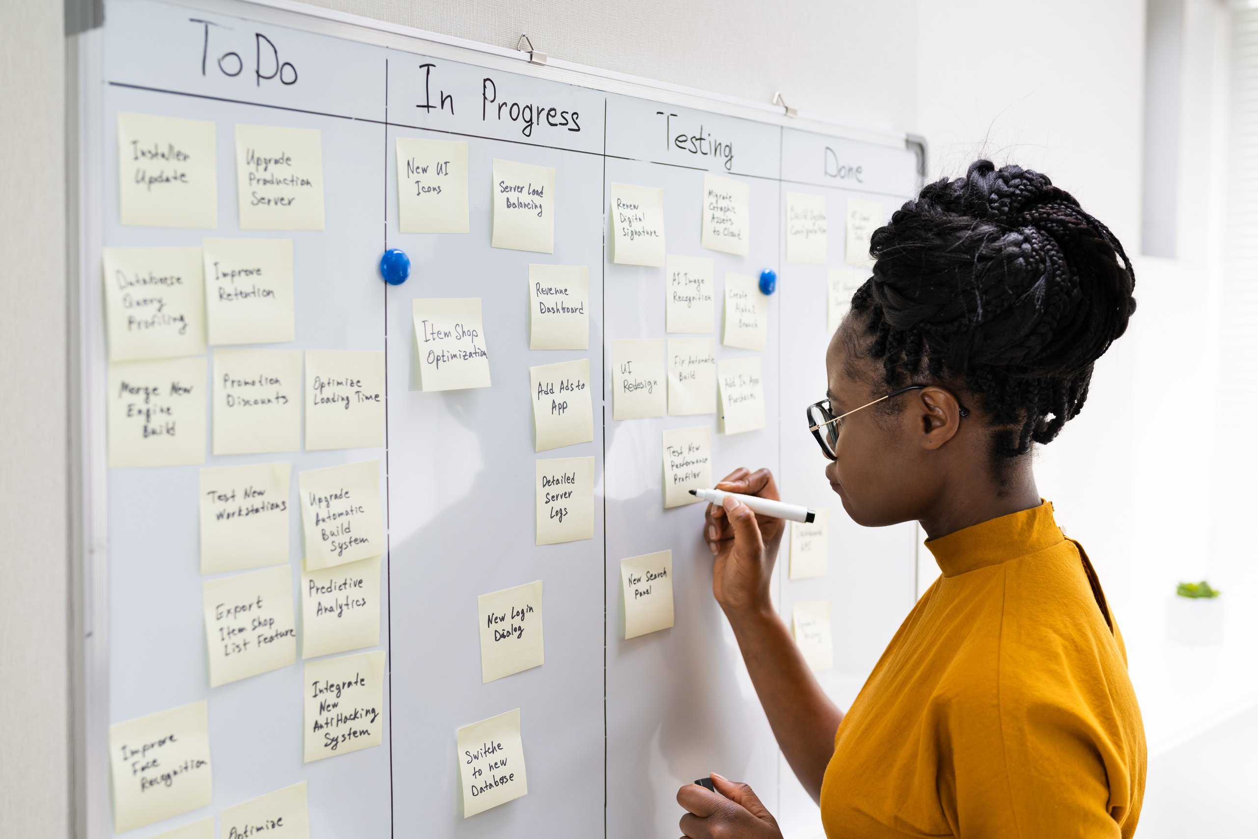 African American Woman Writing Kanban Plan